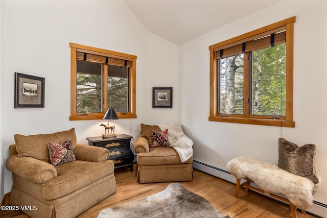 25 Cottage Cir, Edwards, CO 81632 - sitting room with lofted ceiling, wood finished floors, and baseboard heating