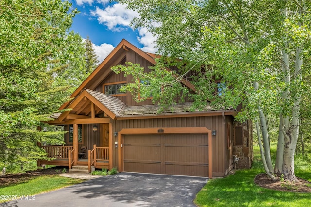 25 Cottage Cir, Edwards, CO 81632 - rustic home featuring driveway, an attached garage, and board and batten siding