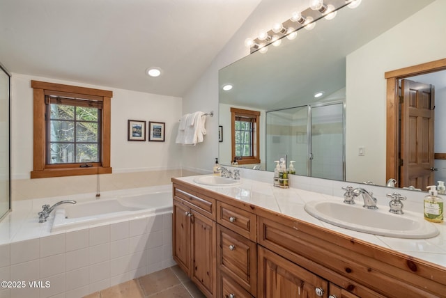 25 Cottage Cir, Edwards, CO 81632 - bathroom featuring double vanity, vaulted ceiling, a garden tub, a stall shower, and tile patterned floors