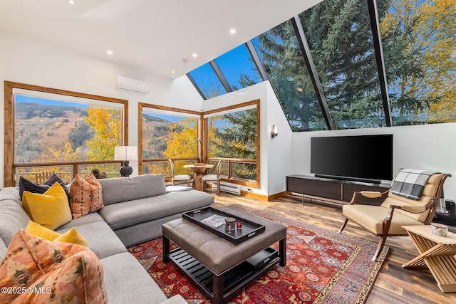 living room with hardwood / wood-style flooring, a wall unit AC, and a high ceiling