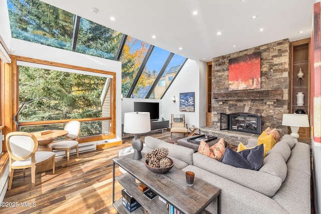 living room with a stone fireplace, a baseboard radiator, and wood-type flooring