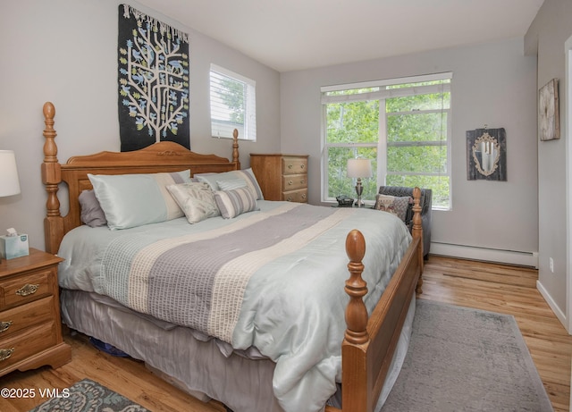 511 Metcalf Rd Unit I27, Avon, CO 81620 - bedroom with a baseboard radiator and light wood-type flooring