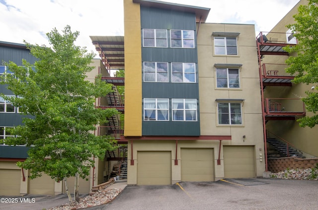 511 Metcalf Rd Unit I27, Avon, CO 81620 - view of property featuring stairway, a garage, and driveway