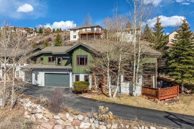 2960 June Creek Trl Unit A, Avon, CO 81620 - view of front of home featuring a garage, driveway, roof with shingles, and a deck
