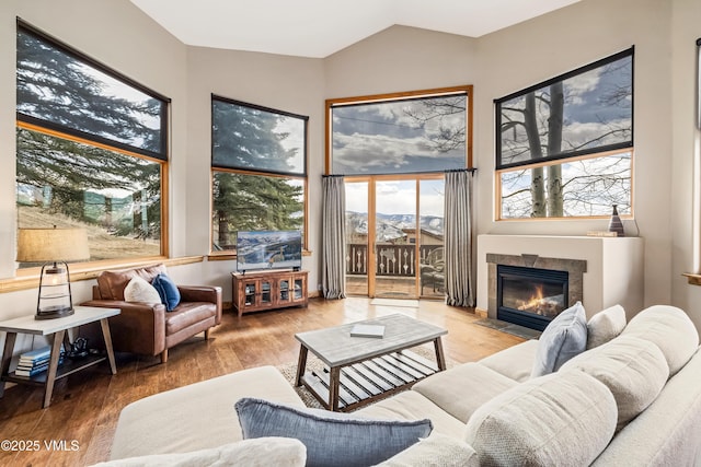 2960 June Creek Trl Unit A, Avon, CO 81620 - living room with a tiled fireplace, wood finished floors, and high vaulted ceiling