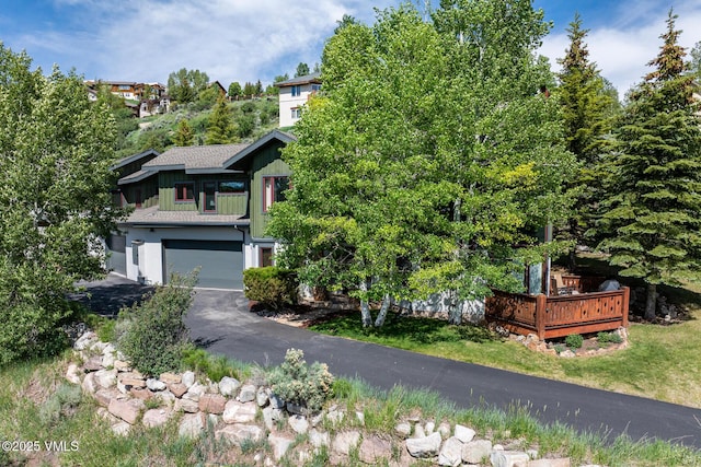 2960 June Creek Trl Unit A, Avon, CO 81620 - view of front of home featuring a garage, asphalt driveway, and a deck