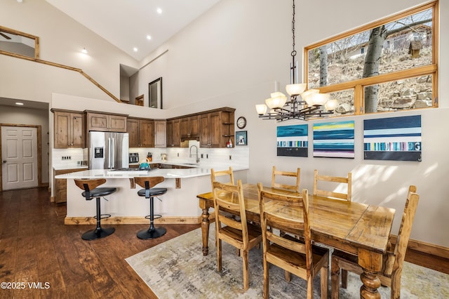 2960 June Creek Trl Unit A, Avon, CO 81620 - dining area with dark wood-type flooring, a chandelier, high vaulted ceiling, and recessed lighting