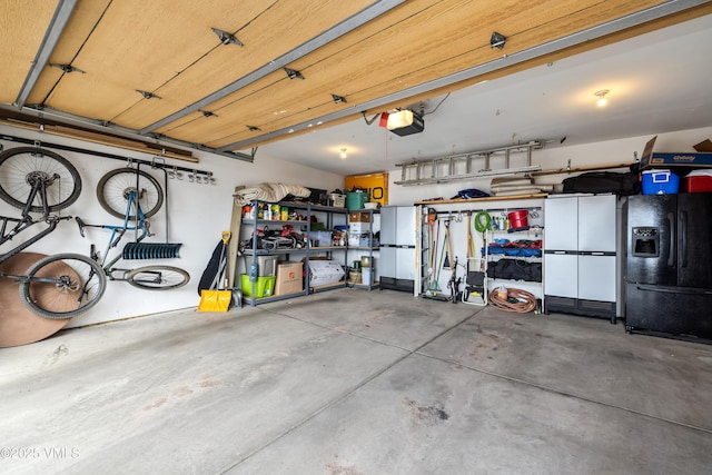 2960 June Creek Trl Unit A, Avon, CO 81620 - garage featuring a garage door opener and black fridge