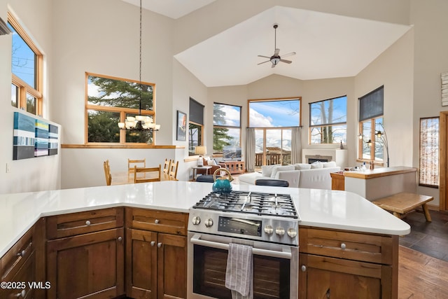 2960 June Creek Trl Unit A, Avon, CO 81620 - kitchen with gas stove, a ceiling fan, plenty of natural light, light countertops, and high vaulted ceiling