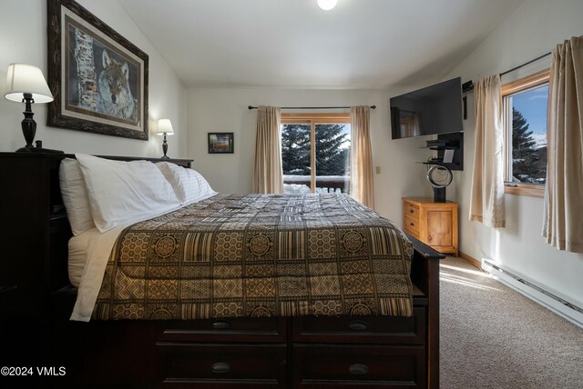 bedroom with vaulted ceiling, a baseboard radiator, access to exterior, and carpet floors