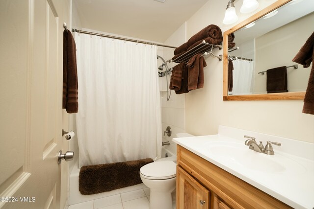 full bathroom featuring tile patterned floors, vanity, toilet, and shower / tub combo with curtain