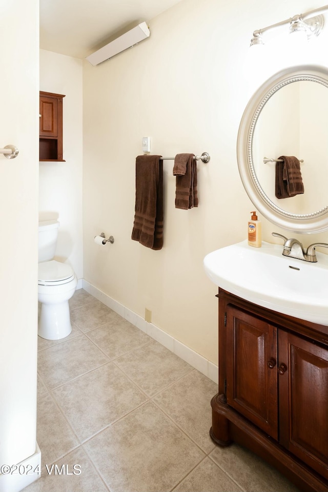 bathroom featuring vanity, toilet, and tile patterned flooring