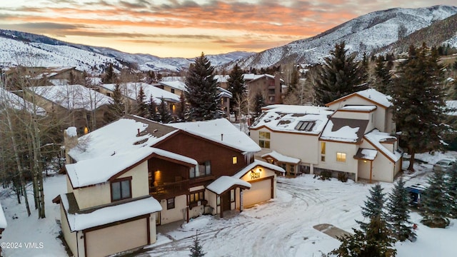 snowy aerial view featuring a mountain view