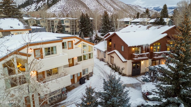 snowy aerial view featuring a mountain view