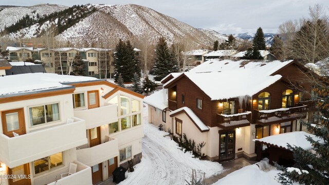 snowy aerial view featuring a mountain view