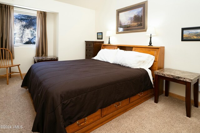 bedroom featuring light carpet