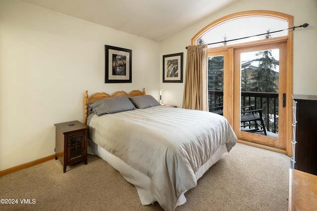 carpeted bedroom with lofted ceiling and access to outside