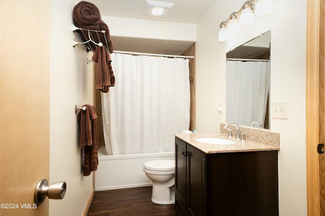 full bathroom with vanity, shower / tub combo, hardwood / wood-style flooring, and toilet