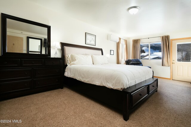 bedroom featuring a wall mounted air conditioner and light carpet