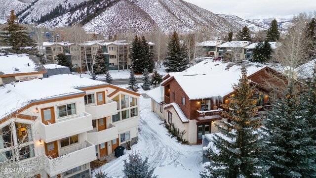 snowy aerial view with a mountain view