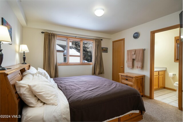 carpeted bedroom featuring connected bathroom