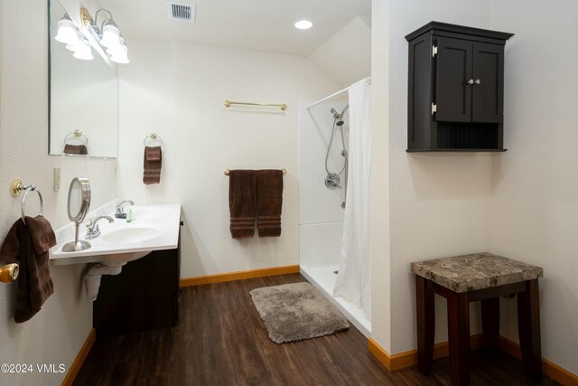 bathroom featuring hardwood / wood-style floors, a shower with curtain, and double sink