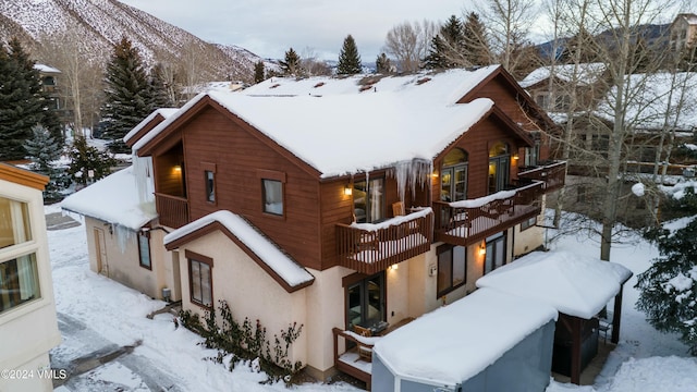 exterior space with a balcony and a mountain view