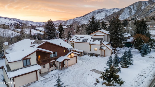 snowy aerial view featuring a mountain view