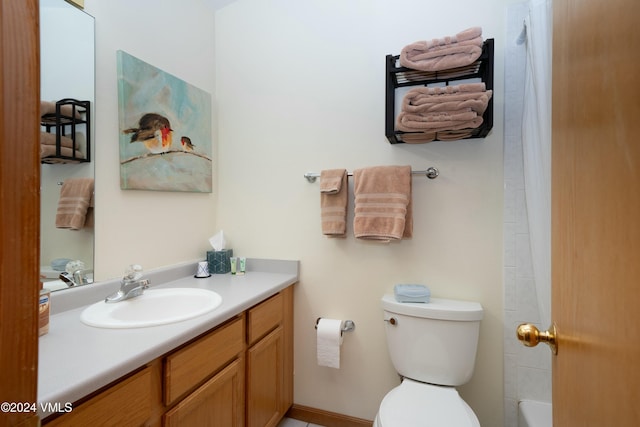 bathroom featuring vanity and toilet