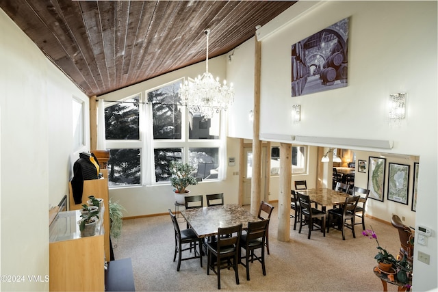 carpeted dining area with an inviting chandelier and wooden ceiling