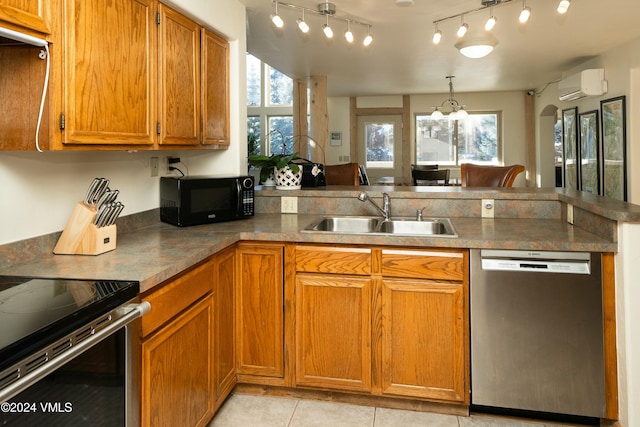 kitchen with light tile patterned flooring, sink, appliances with stainless steel finishes, kitchen peninsula, and a wall unit AC