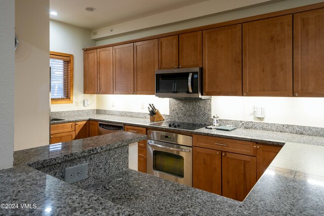 kitchen with tasteful backsplash and appliances with stainless steel finishes