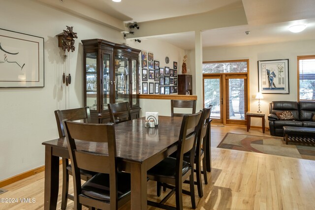 dining space featuring light hardwood / wood-style floors and french doors