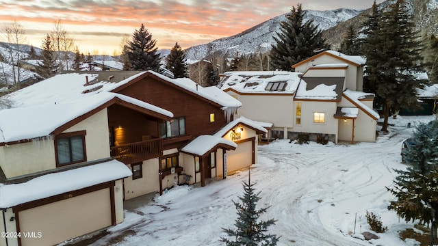 exterior space with a garage, a balcony, and a mountain view