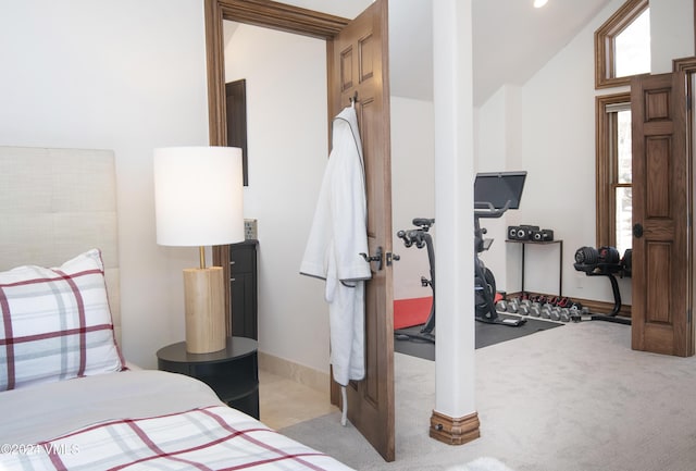 bedroom featuring light colored carpet and vaulted ceiling