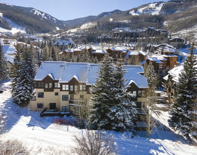 snowy aerial view featuring a mountain view