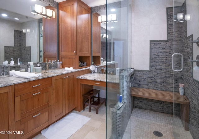 bathroom featuring vanity and a shower with shower door