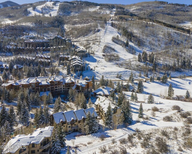 snowy aerial view featuring a mountain view