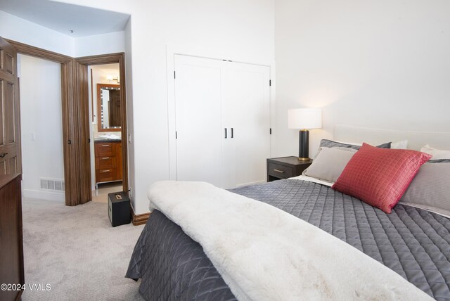 carpeted bedroom featuring a closet