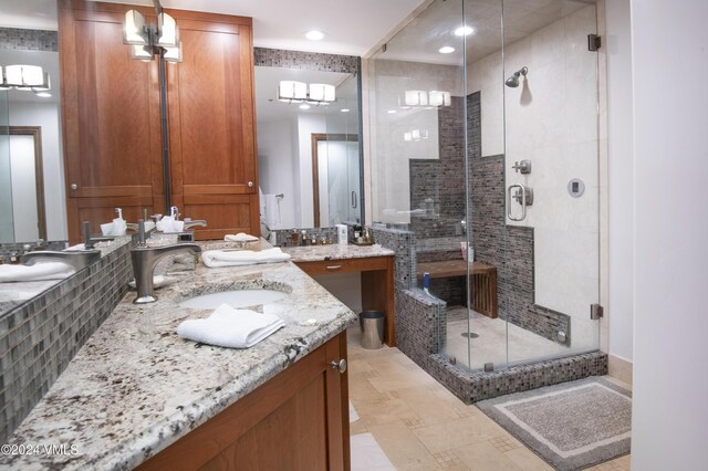 bathroom with vanity and a shower with door