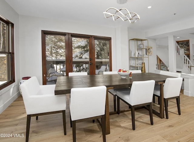 dining area with a notable chandelier and light wood-type flooring