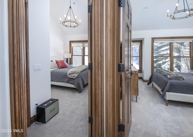 bedroom featuring an inviting chandelier, light colored carpet, and a towering ceiling