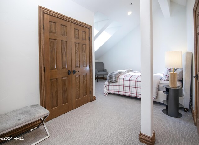 bedroom featuring vaulted ceiling and carpet floors