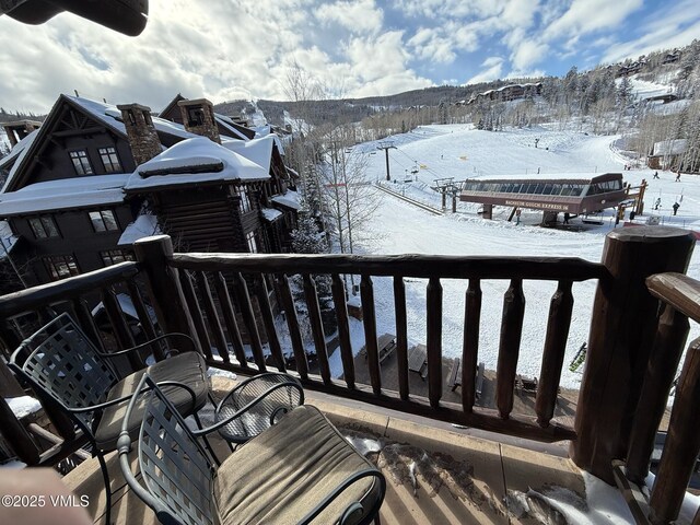 view of snow covered back of property