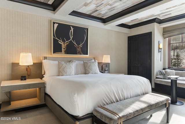 bedroom featuring beamed ceiling and carpet