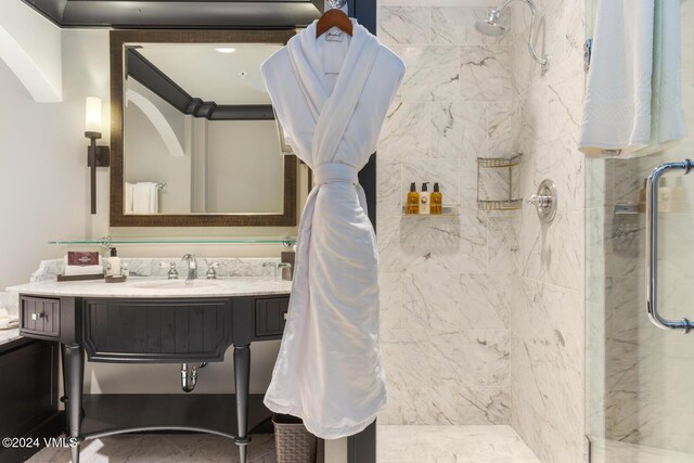 bathroom with vanity and a tile shower