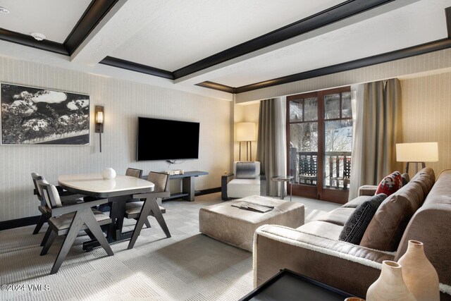 carpeted living room featuring crown molding and beamed ceiling