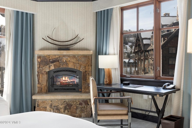 sitting room with a stone fireplace