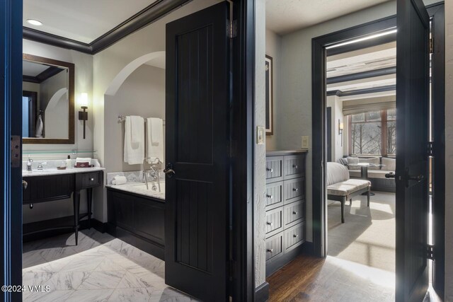 bathroom with crown molding and vanity