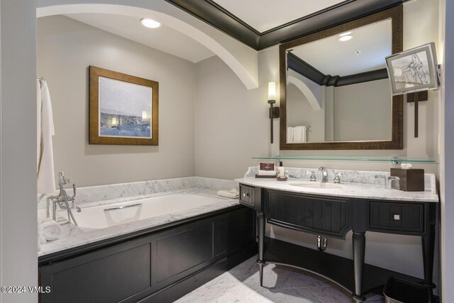 bathroom with vanity and a tub